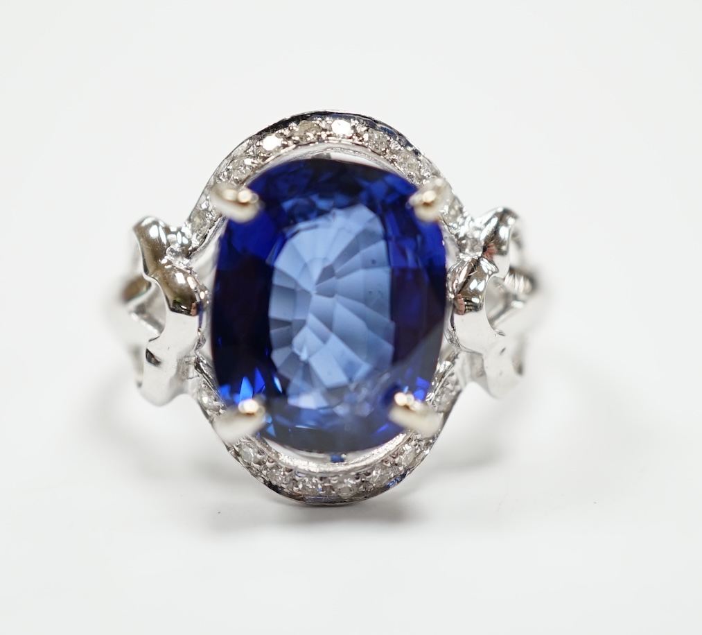 A modern 10k white metal, sapphire and diamond chip set oval cluster set dress ring, size M, gross weight 3.7 grams.